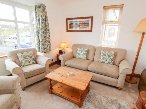a living room with two couches and a coffee table at Eusebank in Pooley Bridge