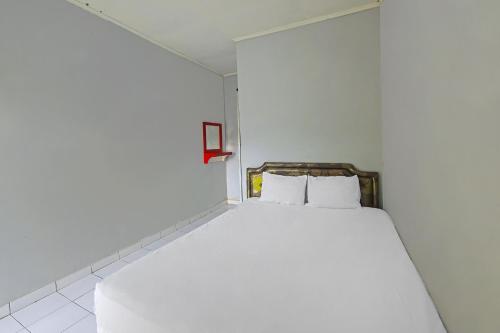 Ένα ή περισσότερα κρεβάτια σε δωμάτιο στο Hotel O Cipto Arum