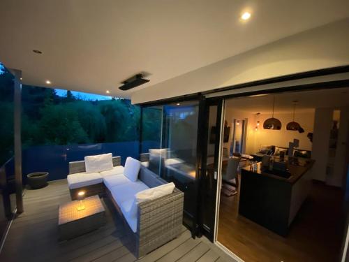 a living room with a white couch on a balcony at Inntal Alpin Apartments - Hohe Munde in Telfs