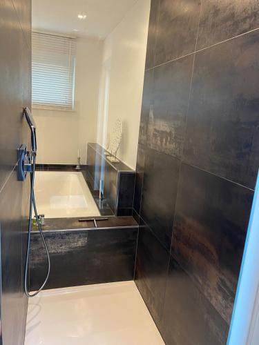 a bathroom with a tub and a shower stall at Inntal Alpin Apartments - Hohe Munde in Telfs