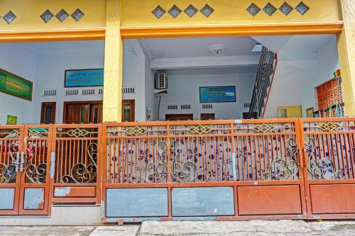 an entrance to a building with a wooden gate at Hotel O Noril Haromain Homestay Syariah in Pasuruan