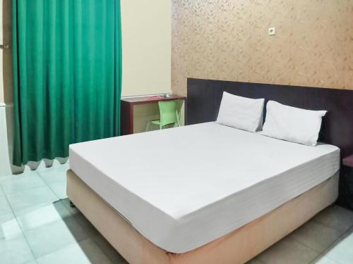Кровать или кровати в номере Hotel O Lima Dara