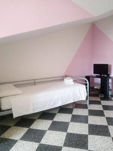 a bedroom with a bed and a checkered floor at Villa Carla in Filattiera