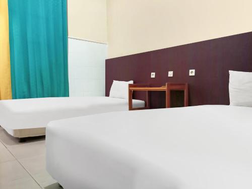Кровать или кровати в номере Hotel O Lima Dara