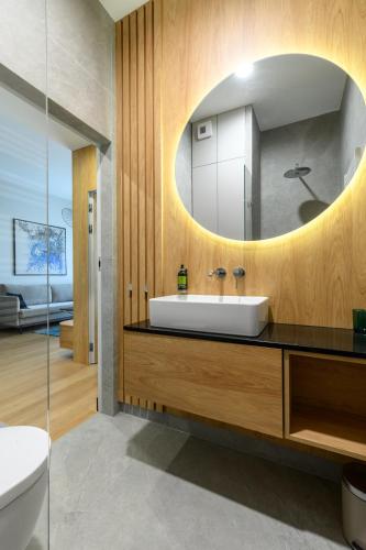 a bathroom with a sink and a mirror at Nad zatoką Ukiel apartamenty przy jeziorze in Olsztyn