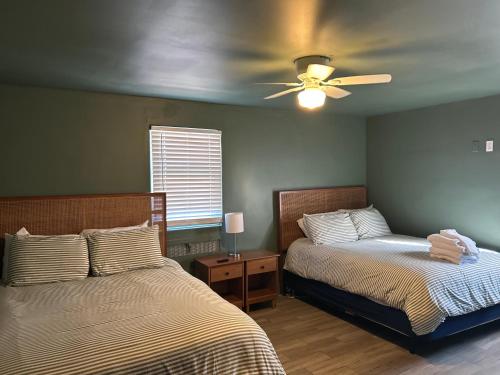 a bedroom with two beds and a ceiling fan at Hidden Gem of the Westside in Providence