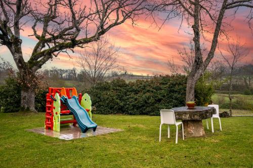 a park with a playground with a table and chairs at Agriturismo Meriggio in Semproniano