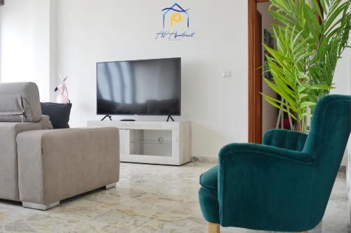 a living room with a couch and a tv at Tropical Paradise x AP Apartment in Gallipoli