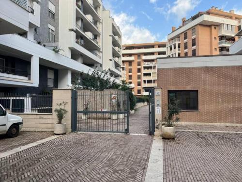 a gate in a brick building with buildings at Confort with Garden in Fiumicino Airport