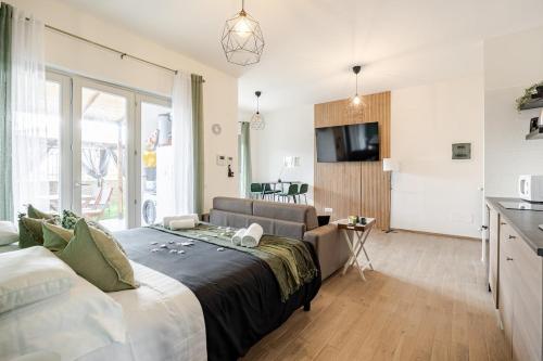 a bedroom with a large bed and a kitchen at Confort with Garden in Fiumicino Airport