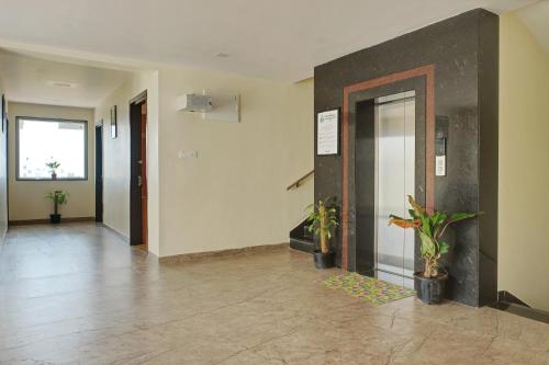 an empty hallway with a lobby with plants on the floor at Treebo Premium Ocean Echo, Rushikonda in Rushikonda