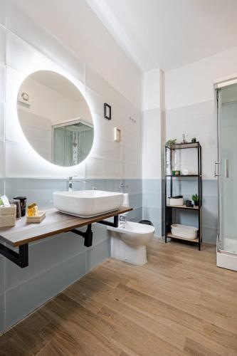 a bathroom with a sink and a toilet and a mirror at Confort with Garden in Fiumicino Airport