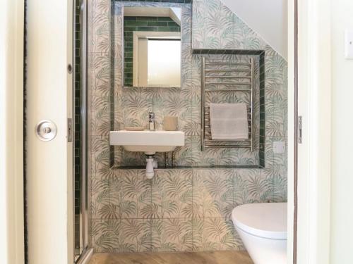 a bathroom with a sink and a mirror at The Cabin at Ropewalk in St. Agnes
