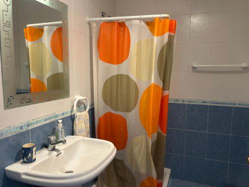 a bathroom with a sink and a shower curtain at casalapita in Carboneras