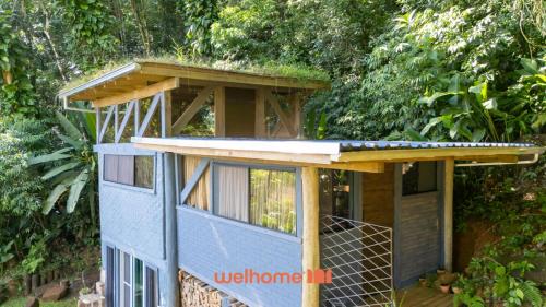 a tiny house with a roof on top of it at Chale na Mata Atlantica com rio e imersao natural in Garuva