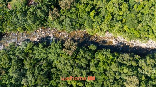 an aerial view of a forest with a red sign at Chale na Mata Atlantica com rio e imersao natural in Garuva