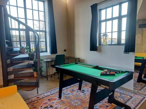 a living room with a pool table and windows at Converted factory loft apartment - Free parking with no height restrictions x 2 in Bristol