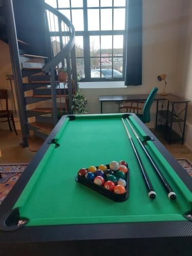 a pool table with cue balls on top of it at Converted factory loft apartment - Free parking with no height restrictions x 2 in Bristol