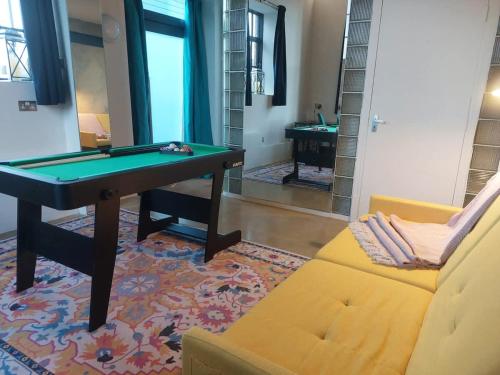 a living room with a pool table and a couch at Converted factory loft apartment - Free parking with no height restrictions x 2 in Bristol