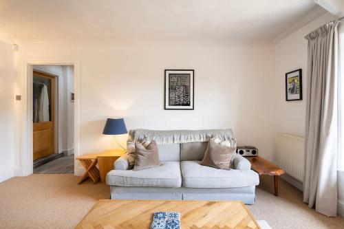 a living room with a white couch and a table at The Mews Flat, near Clifton Suspension Bridge with off-street parking in Bristol