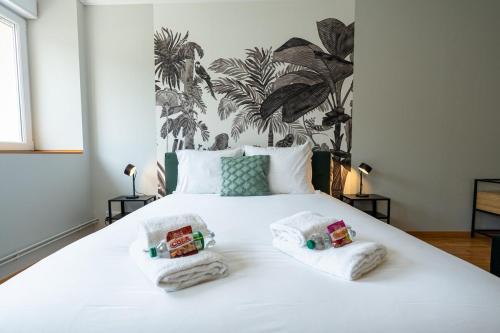 a bedroom with a white bed with two pillows on it at Évasion à Oiry Villa Madeline in Oiry