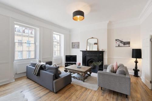 a living room with two couches and a fireplace at Large Luxury City Centre Flat with Balcony in Bristol