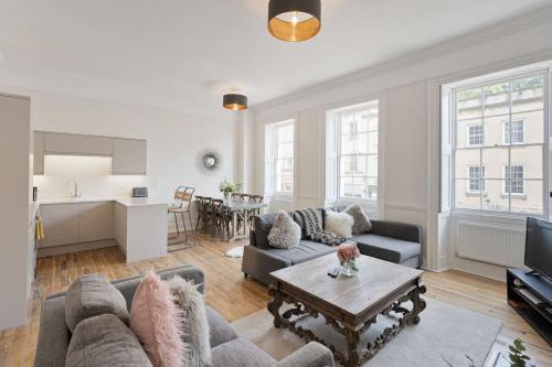 a living room with a couch and a table at Large Luxury City Centre Flat with Balcony in Bristol