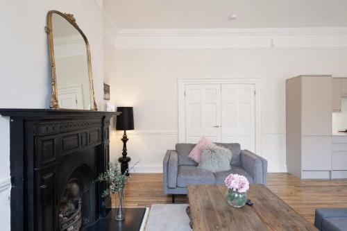 a living room with a couch and a table at Large Luxury City Centre Flat with Balcony in Bristol