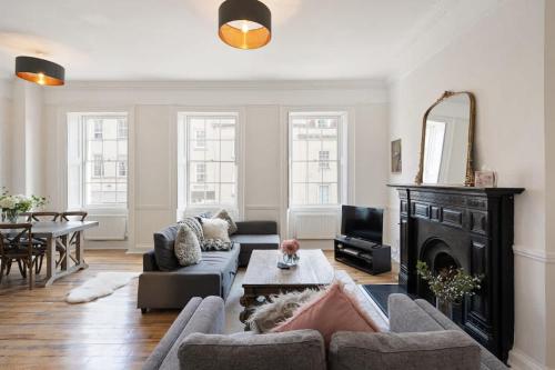 a living room with a couch and a fireplace at Large Luxury City Centre Flat with Balcony in Bristol