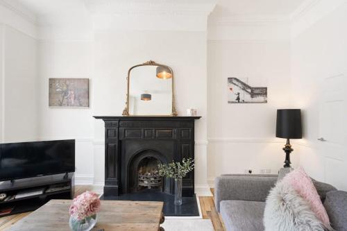 a living room with a fireplace and a tv at Large Luxury City Centre Flat with Balcony in Bristol