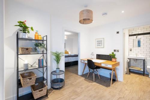 a living room with a desk and a bedroom at The Upside Down Eco House - Free parking with no height restrictions in Bristol