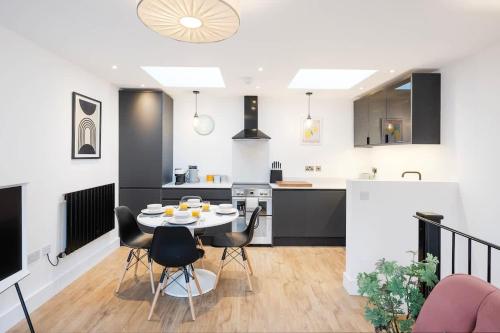 a kitchen and living room with a table and chairs at The Upside Down Eco House - Free parking with no height restrictions in Bristol