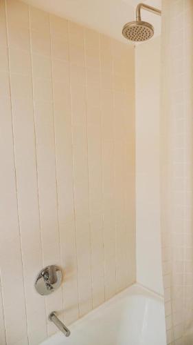 a shower with a shower head in a bathroom at La Uruguaya in Ocean Park