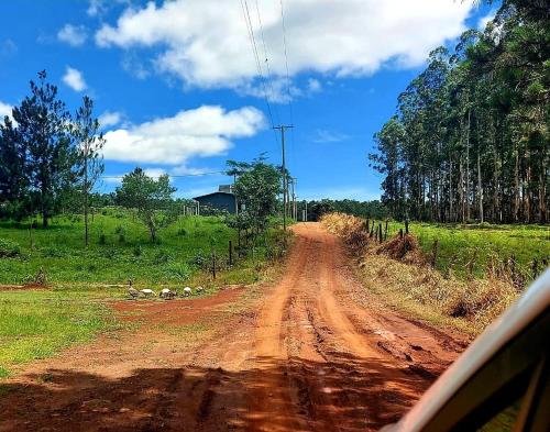 a dirt road with a car driving on it at Casa El Eucaliptal in Puerto Rico