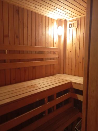 a wooden sauna with a light in the middle at happy home in Bishkek