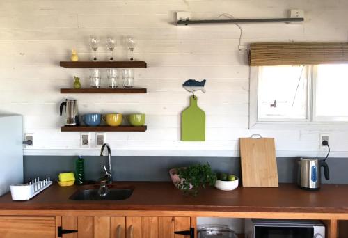 a kitchen with a sink and a counter top at Cabañas Punta Papaya in Punta Del Diablo