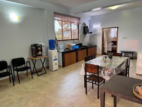 a kitchen with a table and chairs in a room at ZnZ Homestay in Shillong