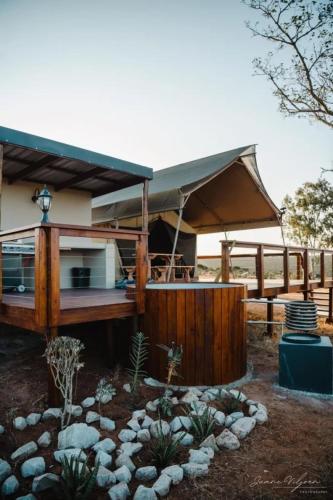 a house with a fence and a yard with rocks at Longhill Reserve in Addo