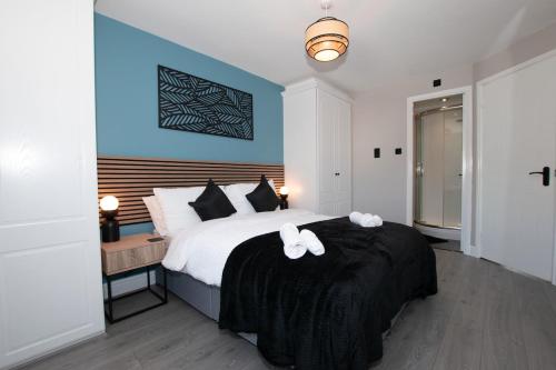 a bedroom with a bed with two white towels on it at Penthouse River View near Edinburgh in Saint Davids