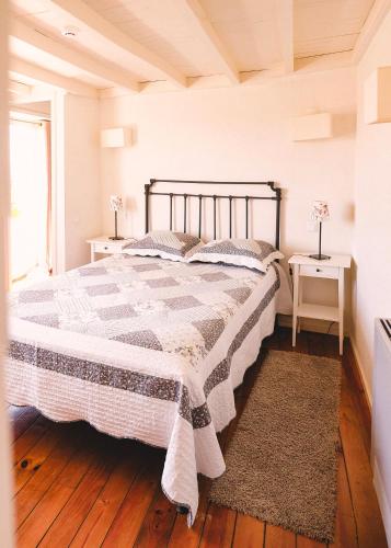 a bedroom with a bed and two night stands at Casal de Tralhariz - Douro Valley in Tralhariz