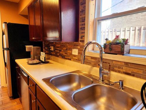 a kitchen with a stainless steel sink and a window at Modern 2 Beds Apt close Downtown in Evanston