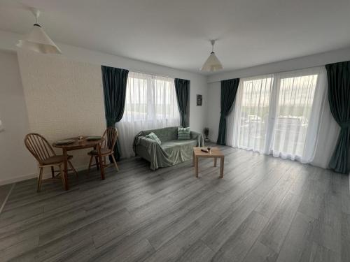 a living room with a couch and a table at Myhouse 2 in Ploieşti