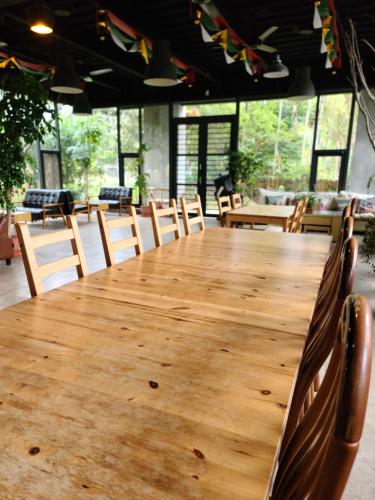 a large wooden table in a room with chairs at 達芭凱民宿 Tabakai B&B in Xinyi