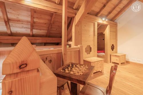 Cette chambre en bois dispose d'un échiquier sur une table. dans l'établissement L'ours, à Montricher-Albanne