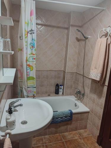 a bathroom with a tub and a sink and a shower at Carpe Diem Bosque in El Bosque