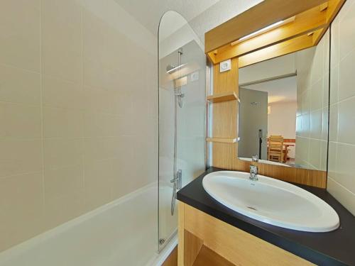une salle de bain avec un lavabo, une douche et un miroir dans l'établissement Appartement 2 pièces au pied des pistes avec casier à ski et WiFi - FR-1-351-198, à La Plagne Tarentaise