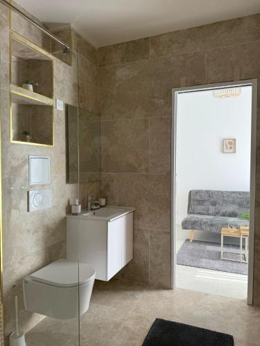 a bathroom with a toilet and a sink and a bed at EXCEPTIONNEL Appartement VERSAILLES in Rocquencourt