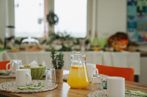 a table with a jug of orange juice on it at Agri B&B Terre Joniche in Isola Capo Rizzuto