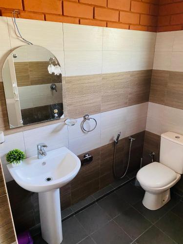 a bathroom with a sink and a toilet at Pearl Shine Bungalow Nuwaraeliya in Nuwara Eliya