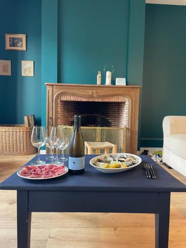 - une table avec une bouteille de vin et des verres à vin dans l'établissement Family Home between Sea and Forest, à Lanton